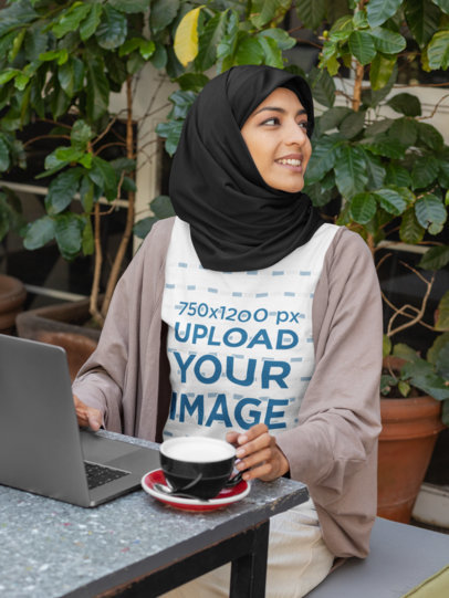 T-Shirt Mockup of a Woman Wearing a Hijab and Working at a Café