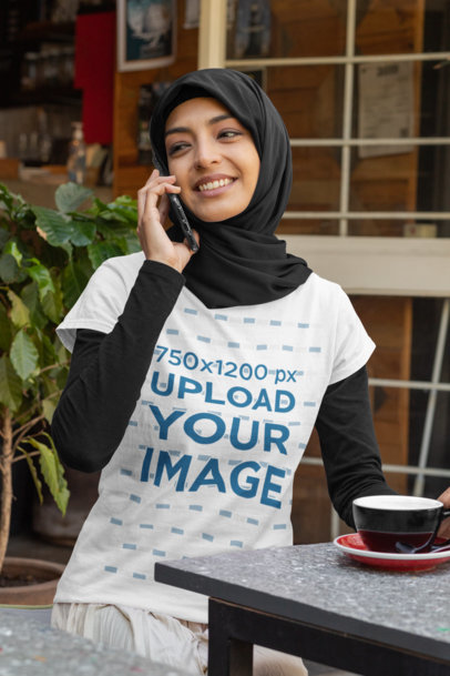 Mockup Featuring a Woman with a T-Shirt Talking on the Phone at a Restaurant 