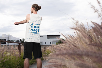 Tank Top Mockup of a Young Man Stretching His Arm