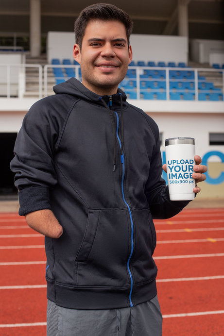Tumbler Mockup Featuring a Man at a Track Field 