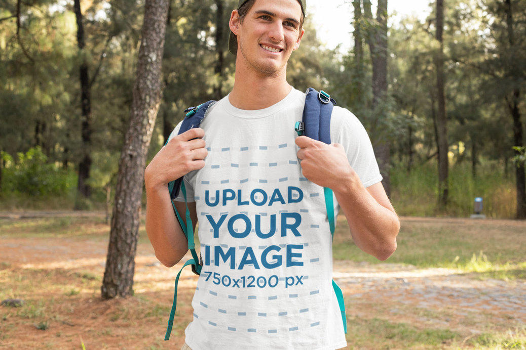 T-Shirt Mockup Featuring a Smiling Man Hiking at the Woods