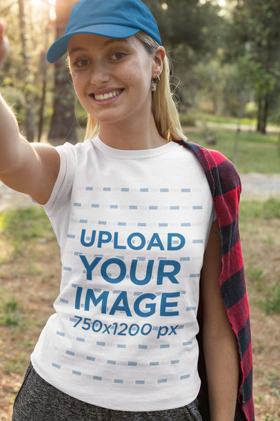 T-Shirt Mockup Featuring a Woman Taking a Selfie in the Forest 