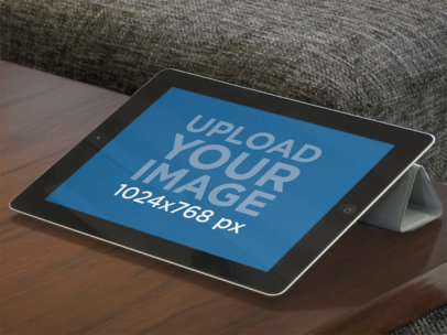  Mockup of an iPad in Landscape Position Placed on a Wooden Coffee Table