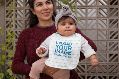 Bib Mockup of a Mom Holding Her Baby 