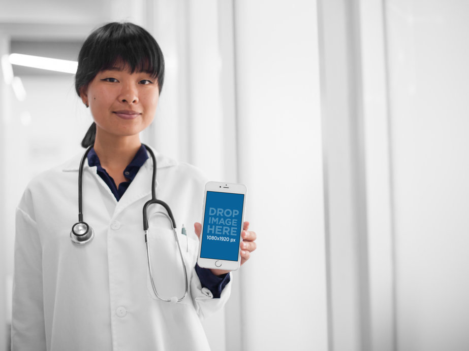 Mockup of a Female Doctor Showing an iPhone 6 in Portrait Position 