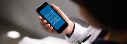 Black iPhone 6 Mockup Held by a Doctor in Portrait Position