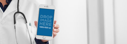 iPhone Mockup Featuring a Doctor Holding an iPhone 6 in Frontal View
