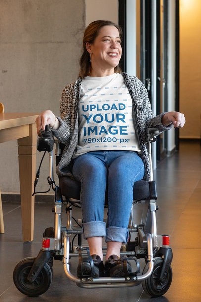 T-Shirt Mockup of a Smiling Woman Using a Wheelchair in a Hall