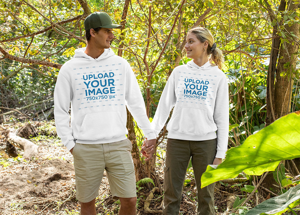 Hoodie Mockup of a Couple Holding Hands in the Woods