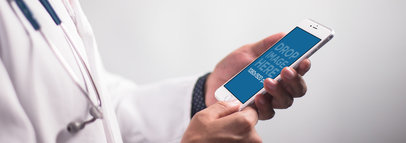 iPhone 6 Plus Mockup Featuring a Doctor Holding an iPhone in Portrait Position