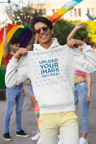 Mockup of a Man Showing off His Hoodie at the Pride Parade 