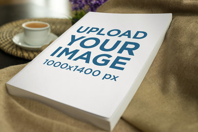 Mockup of a Paperback Book Lying Near a Coffee Table