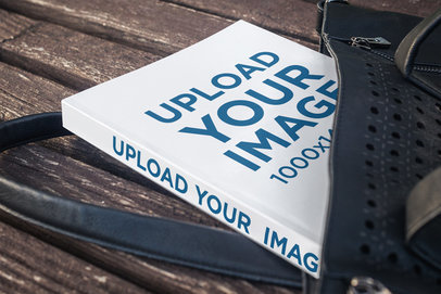 Mockup of a Softcover Book Lying Just Outside of a Purse 3419-el1