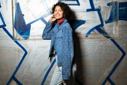 Mockup of a Young Woman Wearing a Denim Jacket at an Urban Setting 