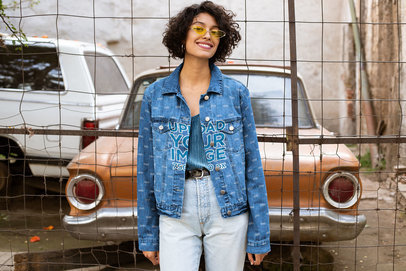 Mockup of a Happy Woman Wearing a Denim Jacket in a Vintage Setting 