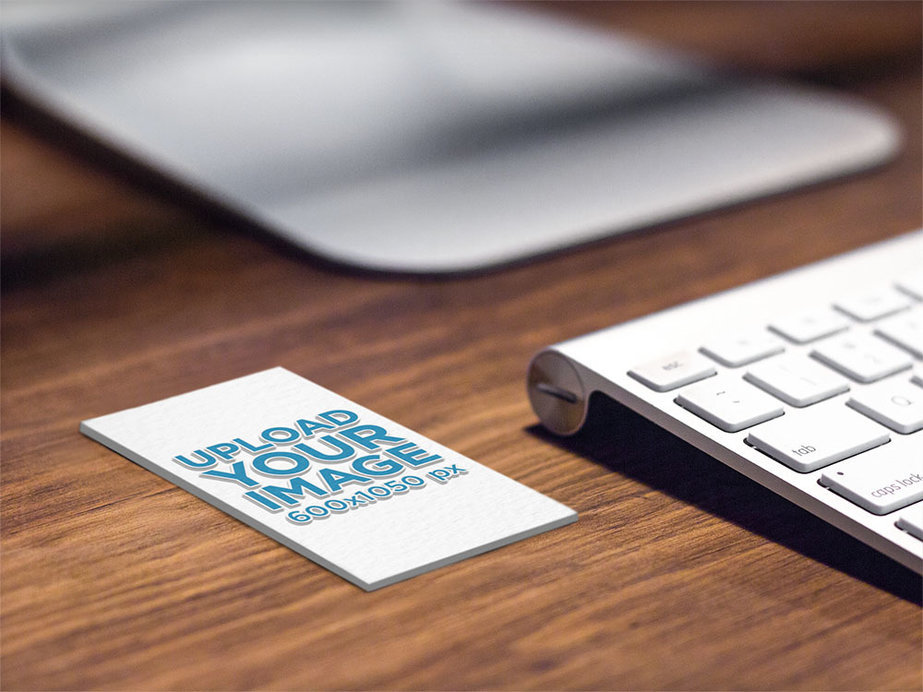 Mockup of an Embossed Vertical Business Card on a Desk