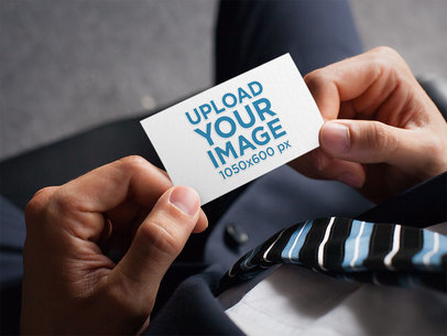 Mockup of a Man Holding a Business Card with an Embossed Texture