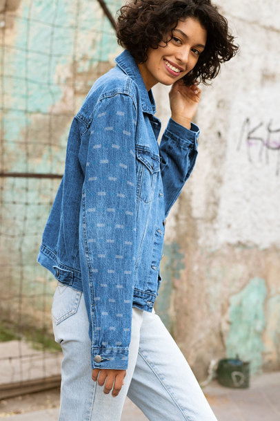 Denim Jacket Mockup Featuring a Short-Haired Woman Posing by an Old Wall 32567