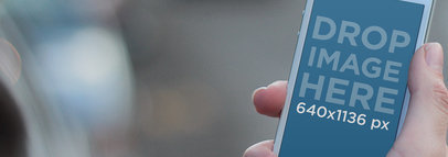 Woman Holding White iPhone 5 In Traffic Wide