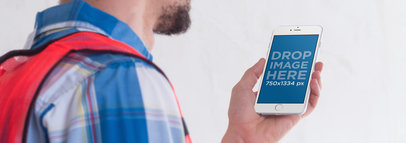 White iPhone 6 Mockup Held by a Construction Worker in Portrait Position