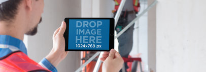 Black iPad Mini Mockup Featuring an Architect Using his iPad a12428