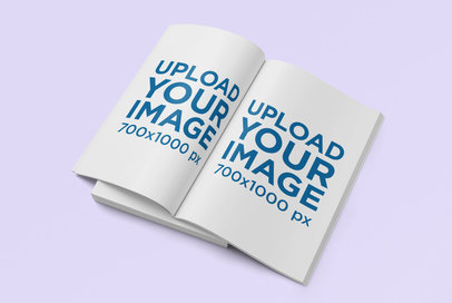 Mockup Featuring an Open Customizable Magazine Against a Plain Color Surface