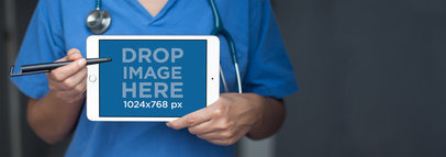 iPad Mini in Landscape View Mockup of a Doctor Pointing to it
