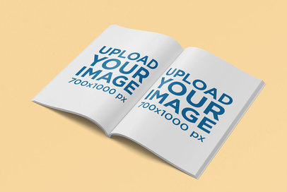 Mockup of an Open A4 Magazine Placed Over a Colored Surface 