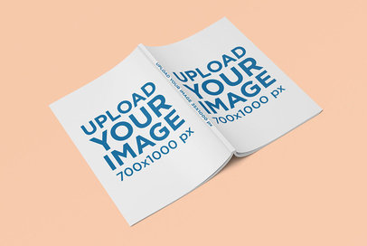 Mockup Featuring a Magazine Lying Open Over a Colored Surface