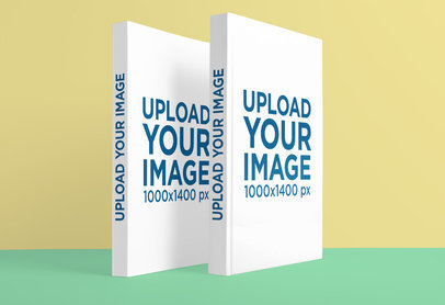 Mockup of Two Hardcover Books Standing Against a Flat Background