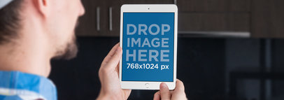 Mockup of a Construction Worker Holding an iPad in Portrait Position