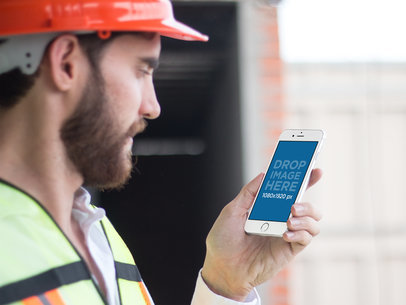 Side Mockup of a Bearded Man Holding an iPhone in Portrait Mode