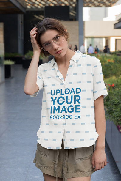 Mockup of a Young Woman Wearing a Customizable Button-Up Shirt 
