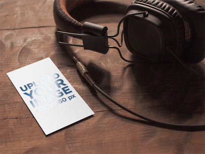 Mockup of a Varnish Business Card Placed Next to a Pair of Headphones 