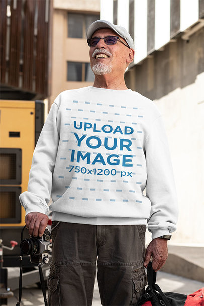 T-Shirt Mockup of a Senior Man with Sunglasses Holding a Camera