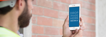 iPhone 6 Mockup Held by a Civil Engineer in Portrait Position