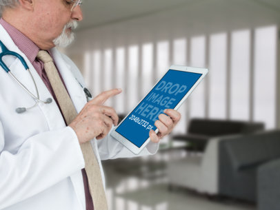 Mockup Featuring a Senior Doctor Using an iPad Pro in Portrait Position 