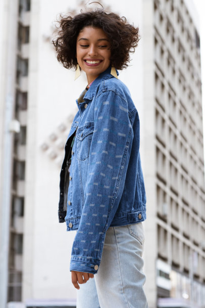 Sleeve Mockup Featuring a Joyful Woman Wearing a Denim Jacket in the City 