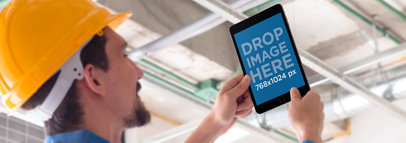 iPad Mini Mockup of an Architect Taking a Picture a12430