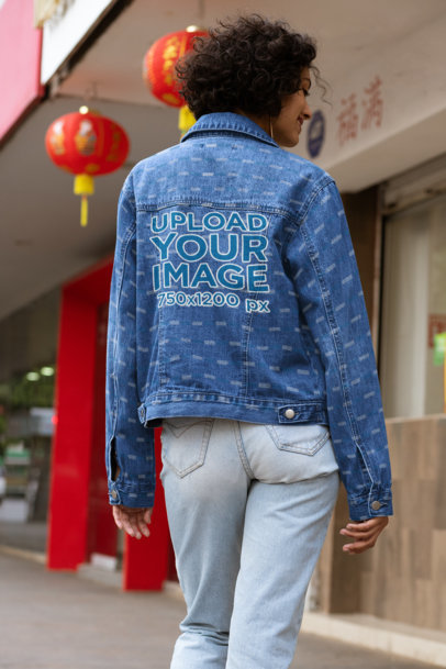 Back View Mockup of a Woman with a Denim Jacket Posing by a Chinese Restaurant 