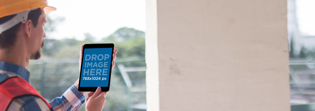 Black iPad Mini Mockup of a Civil Engineer Working