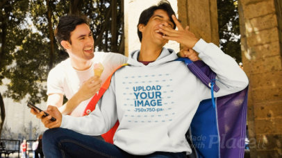 Hoodie Mockup Featuring a Couple Playing with an Ice-Cream