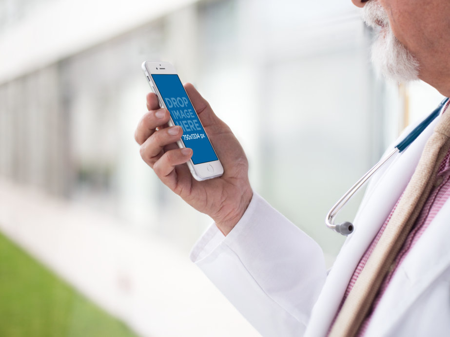 Side Mockup of a Doctor Looking at His iPhone in Portrait Mode