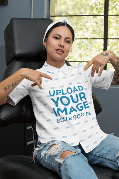 Mockup of a Tattooed Woman Pointing at Her Button-Up Shirt 