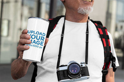 Mockup of a Senior Man Holding a 20 oz Travel Mug
