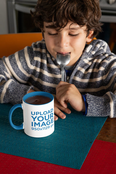 Mockup of a Boy Staring at an 11 oz Coffee Mug With a Colored Rim 