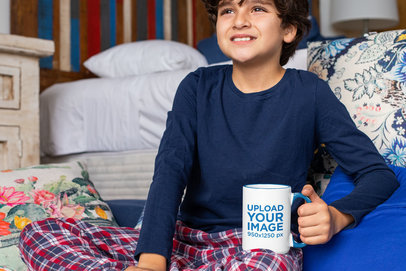Mockup of a Boy Holding a 15 oz Colored Rim Mug at Home 33170