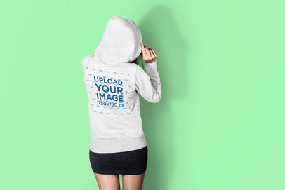 Back View Hoodie Mockup Featuring a Woman at a Studio