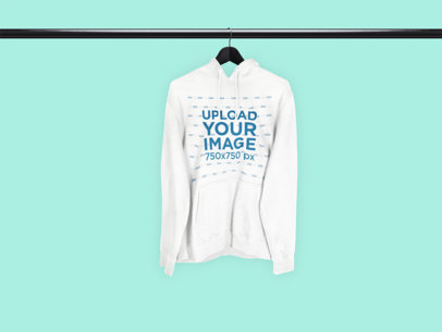 Mockup of a Hoodie Hanging from a Black Metal Tube 