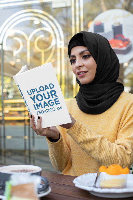 Mockup of a Woman at a Coffee Store Reading a Book and Eating 